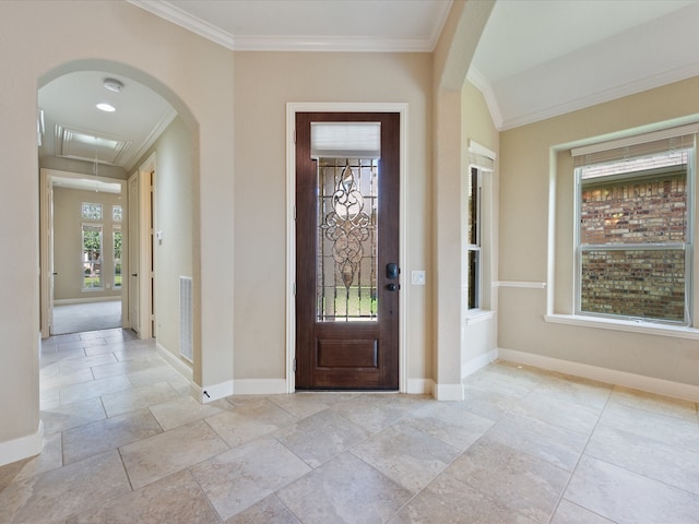 foyer entrance featuring crown molding