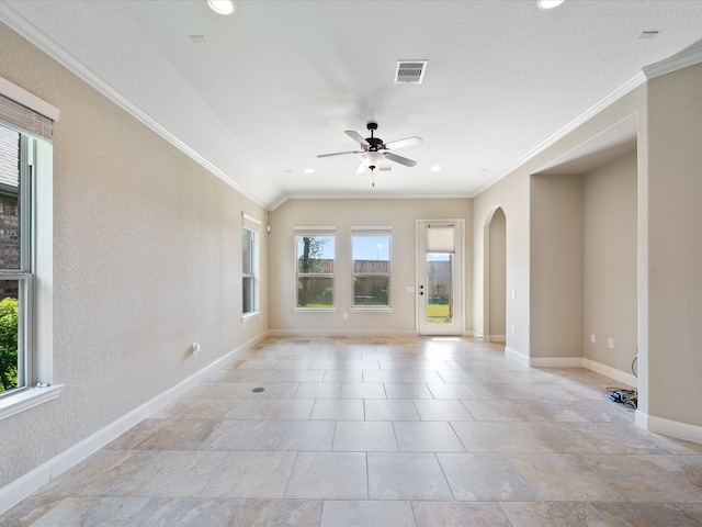 unfurnished room with ceiling fan and crown molding