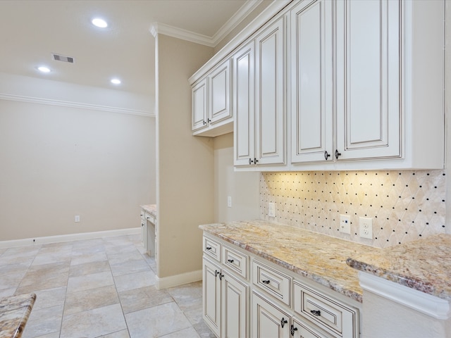 kitchen with tasteful backsplash, light stone countertops, and crown molding