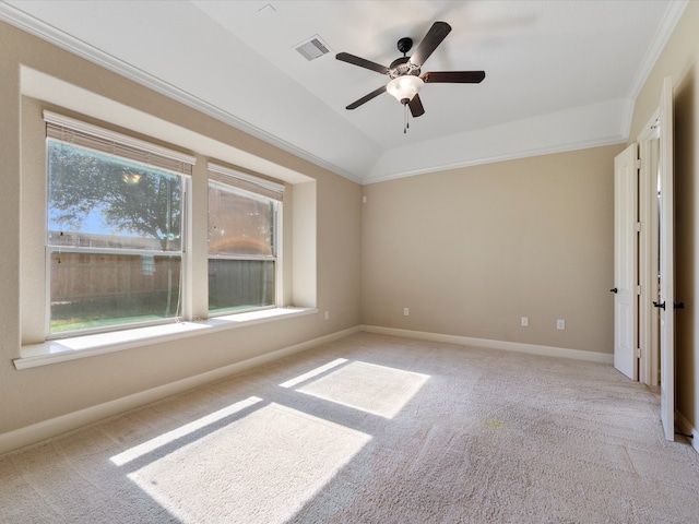 empty room with light carpet, ceiling fan, crown molding, and vaulted ceiling