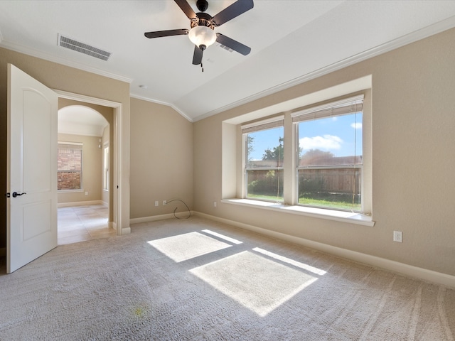 carpeted empty room featuring lofted ceiling, ceiling fan, and crown molding