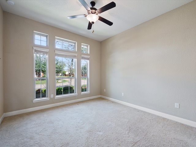 unfurnished room featuring carpet and ceiling fan