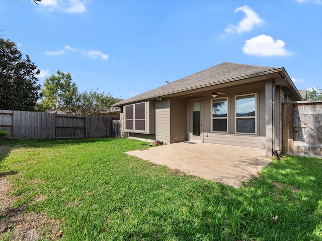 rear view of property featuring a patio, a yard, and ceiling fan