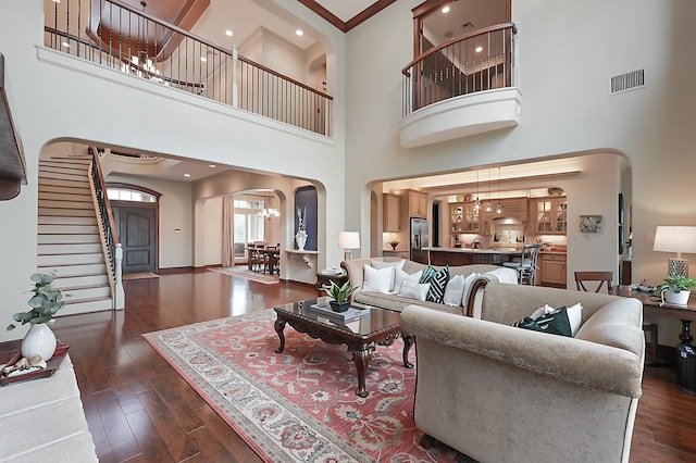 living room featuring dark wood-type flooring and a high ceiling