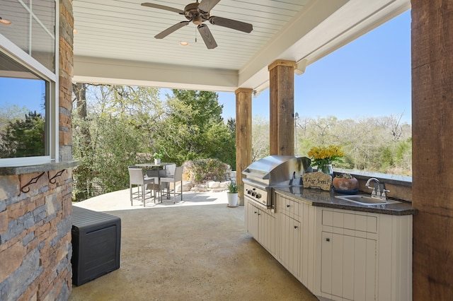 view of patio / terrace with an outdoor kitchen, sink, a grill, and ceiling fan