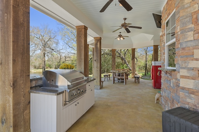 view of patio / terrace with area for grilling, ceiling fan, and a water view