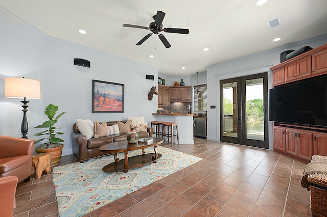 tiled living room with french doors, crown molding, and ceiling fan