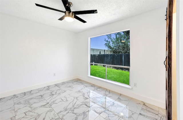 unfurnished room featuring a textured ceiling and ceiling fan