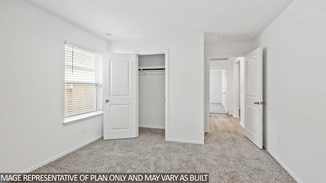 unfurnished bedroom featuring a closet and light carpet