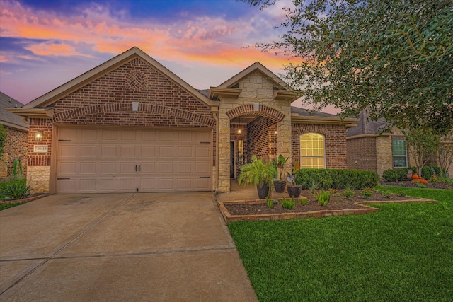 view of front of home with a lawn and a garage