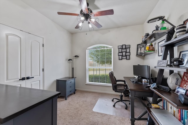 carpeted home office featuring ceiling fan