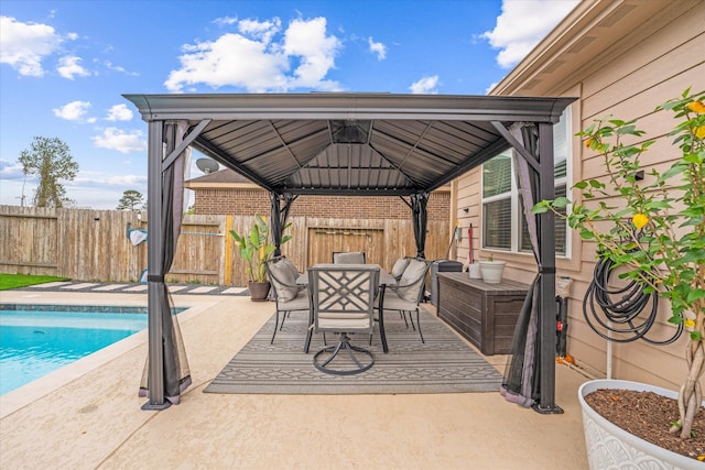 view of patio / terrace featuring a gazebo and a fenced in pool