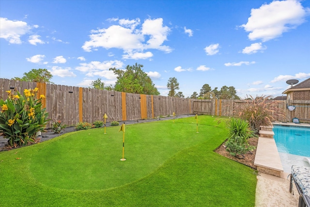 view of yard with a fenced in pool