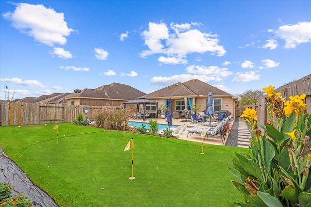 back of property with a patio area and a fenced in pool