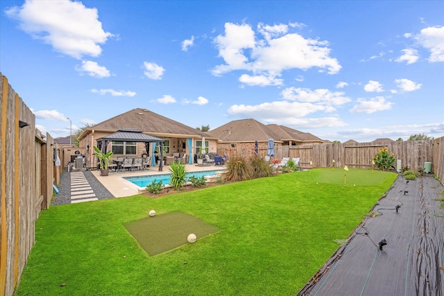 view of yard featuring a fenced in pool, a gazebo, and a patio