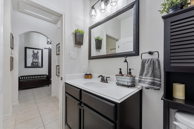 bathroom with vanity, toilet, and tile patterned flooring