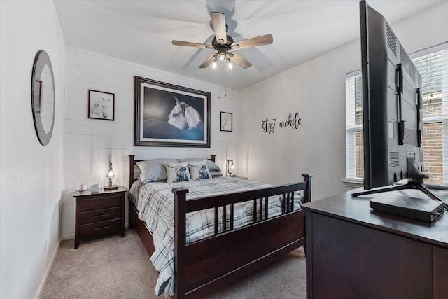 bedroom featuring light carpet and ceiling fan