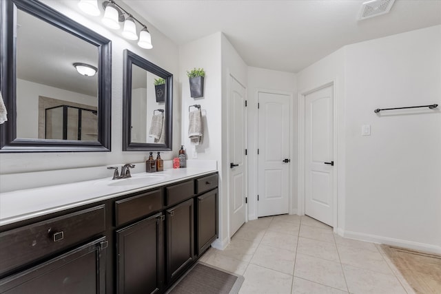 bathroom with vanity, walk in shower, and tile patterned floors