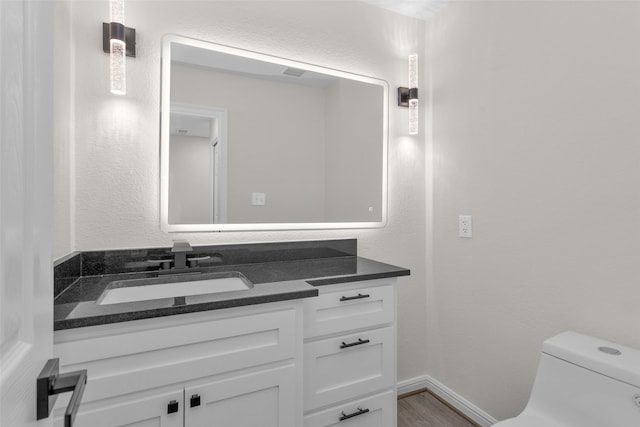 bathroom featuring vanity, toilet, and wood-type flooring