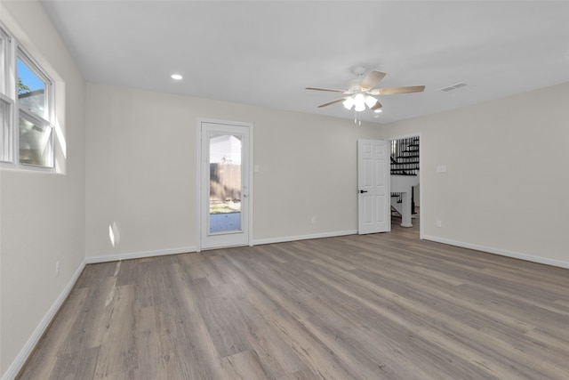 unfurnished room with light wood-type flooring and ceiling fan