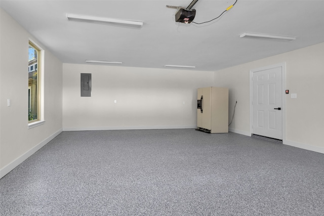 garage featuring a garage door opener, fridge, and electric panel