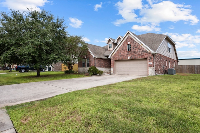 view of front of house with a front lawn, central AC unit, and a garage