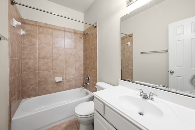 full bathroom featuring tiled shower / bath, tile patterned floors, vanity, and toilet