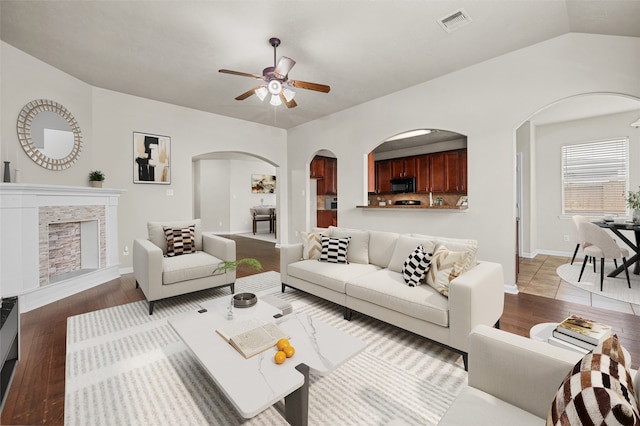 living room featuring wood-type flooring, ceiling fan, and lofted ceiling