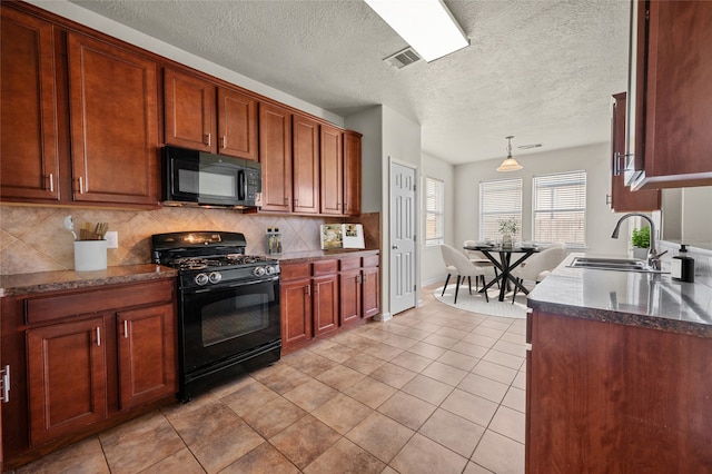 kitchen with black appliances, light tile patterned floors, sink, and tasteful backsplash