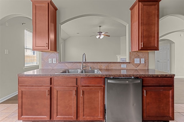 kitchen with backsplash, sink, light tile patterned floors, dishwasher, and lofted ceiling