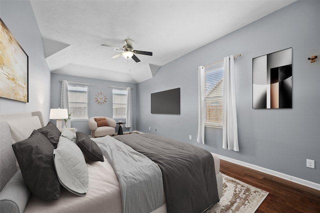 bedroom featuring multiple windows, ceiling fan, and dark wood-type flooring