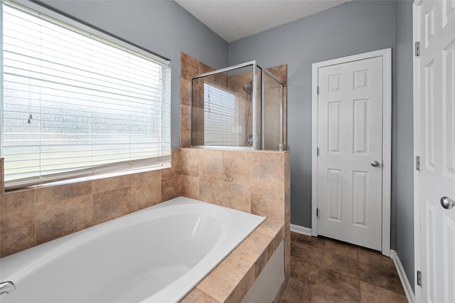 bathroom with tile patterned floors and independent shower and bath