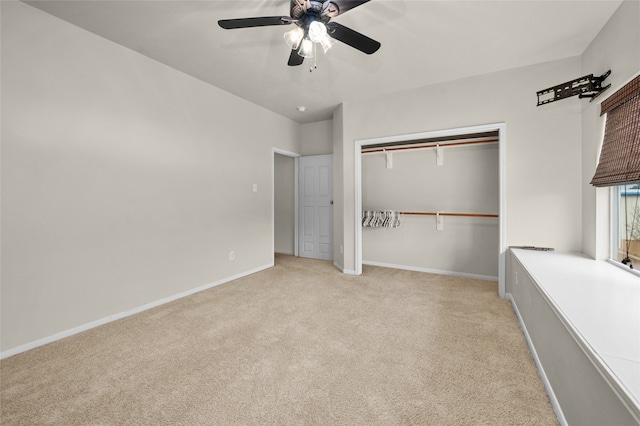 unfurnished bedroom featuring ceiling fan, a closet, and light colored carpet