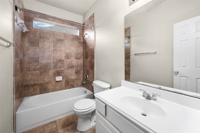 full bathroom featuring tile patterned floors, vanity, toilet, and tiled shower / bath