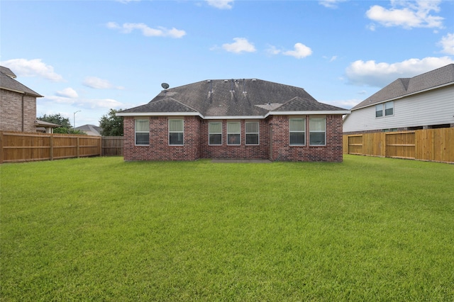 rear view of property with a yard