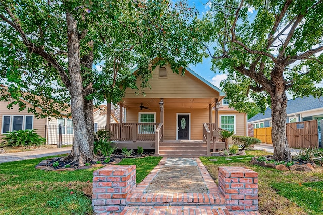 bungalow featuring covered porch and ceiling fan