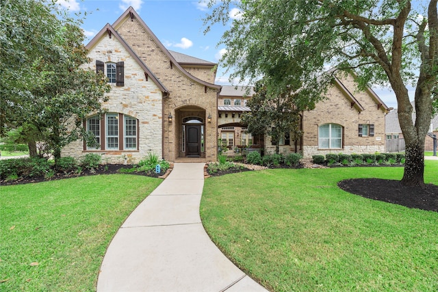 french country home with a front lawn