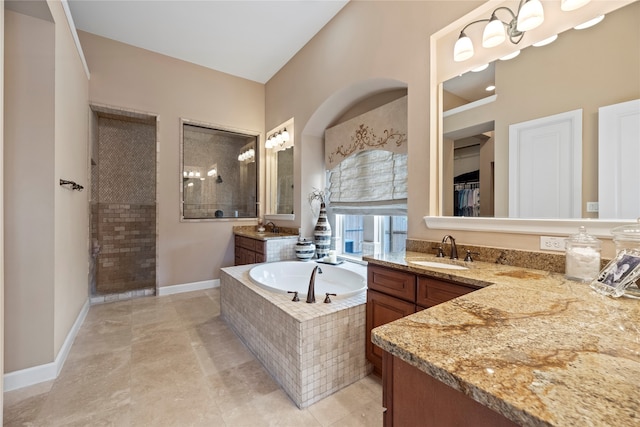 bathroom featuring vanity and separate shower and tub