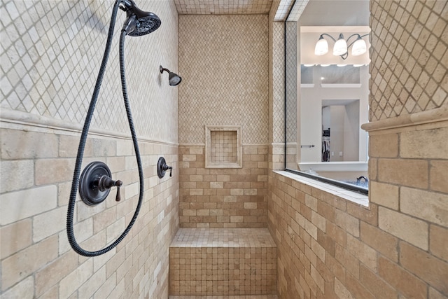 bathroom with tile walls and tiled shower