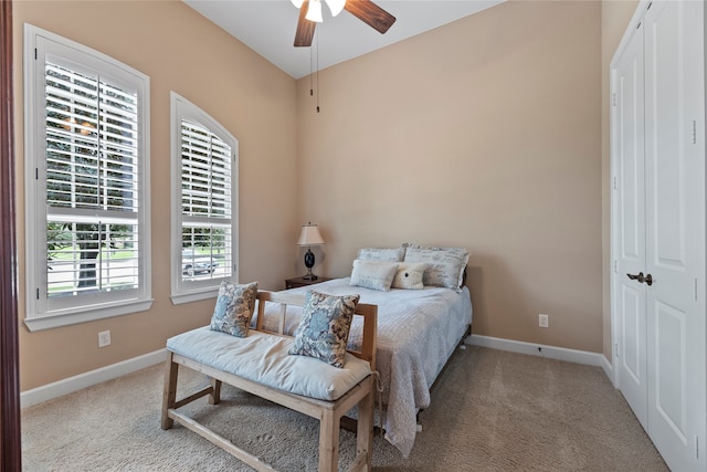 carpeted bedroom with a closet and ceiling fan