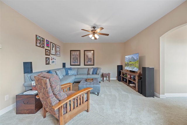 carpeted living room with ceiling fan