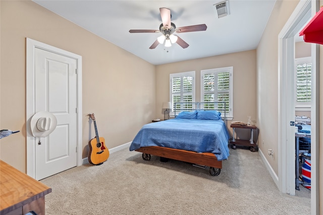 bedroom featuring ceiling fan and light carpet