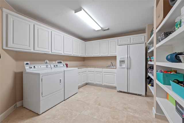 laundry area with cabinets and washing machine and clothes dryer