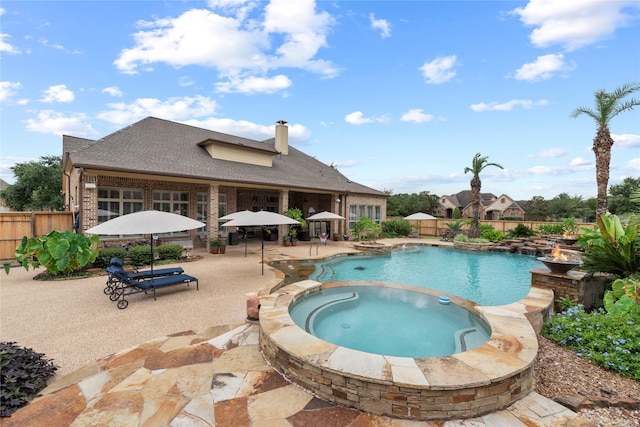 view of swimming pool featuring a patio and an in ground hot tub