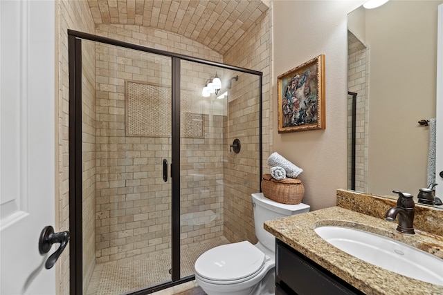 bathroom with vanity, toilet, and a shower with shower door