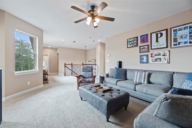 carpeted living room featuring ceiling fan