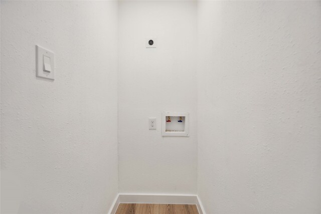 clothes washing area with electric dryer hookup, wood-type flooring, and hookup for a washing machine