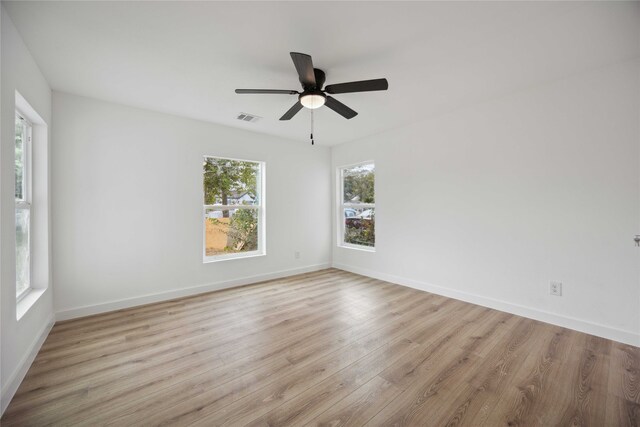 spare room featuring light wood-type flooring and ceiling fan