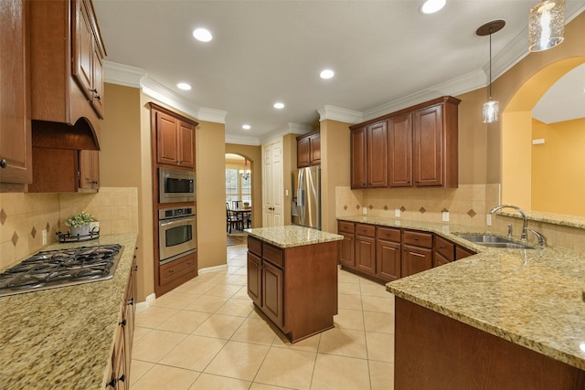 kitchen with light stone countertops, stainless steel appliances, crown molding, sink, and hanging light fixtures