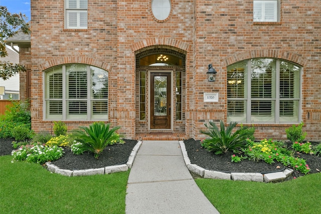 doorway to property featuring a lawn